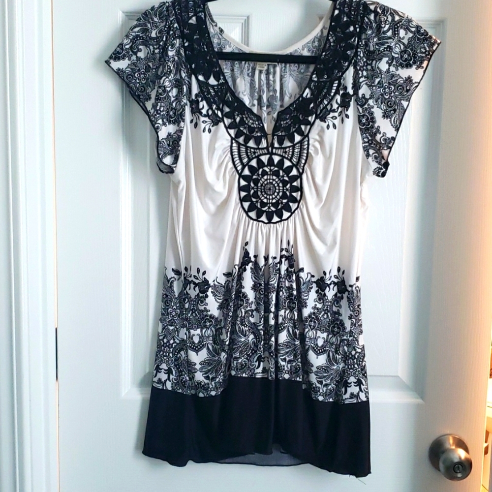 Silky white with black design, short sleeve shirt.